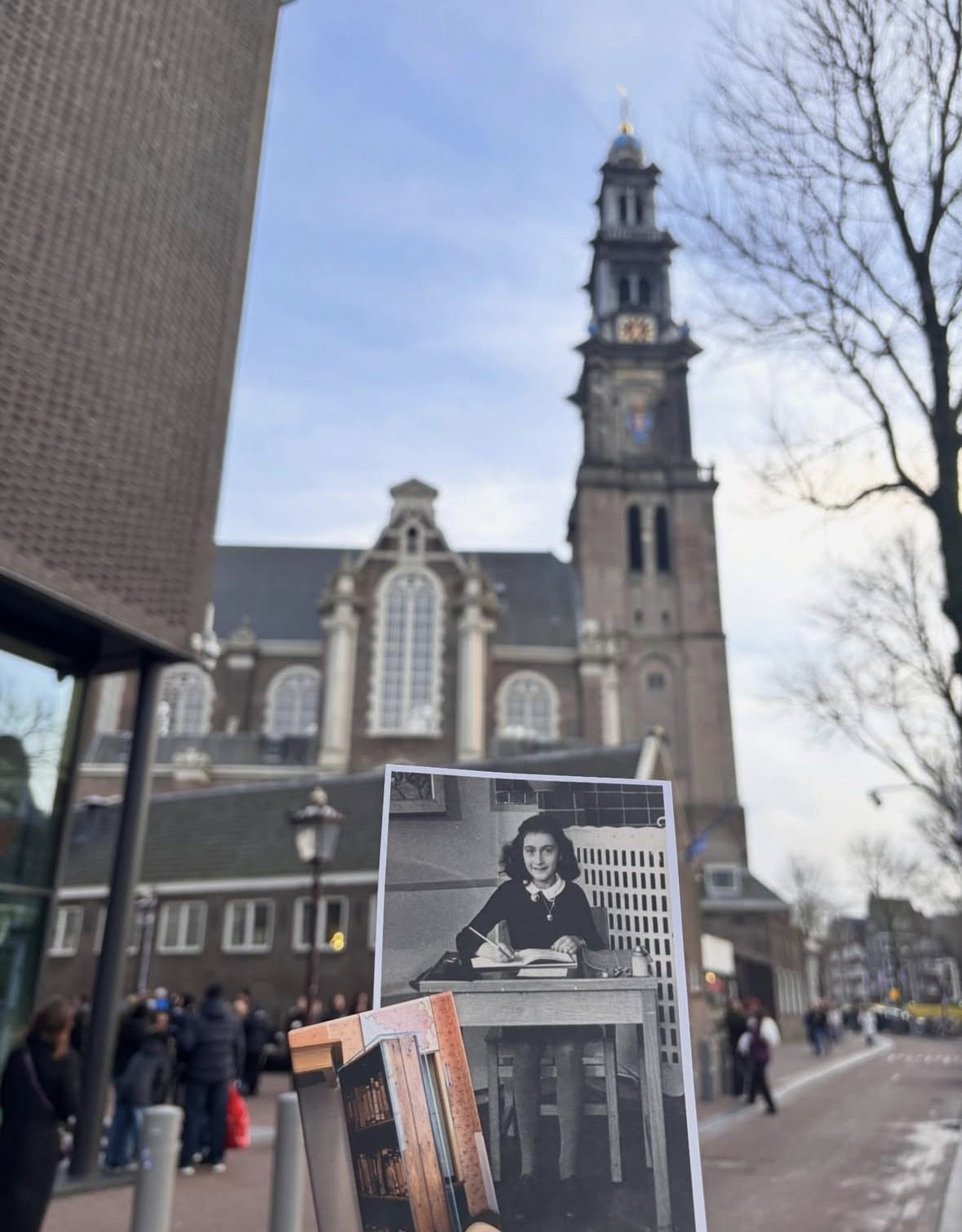 Anne Frank House canal-side facade in Amsterdam with visitors queuing outside